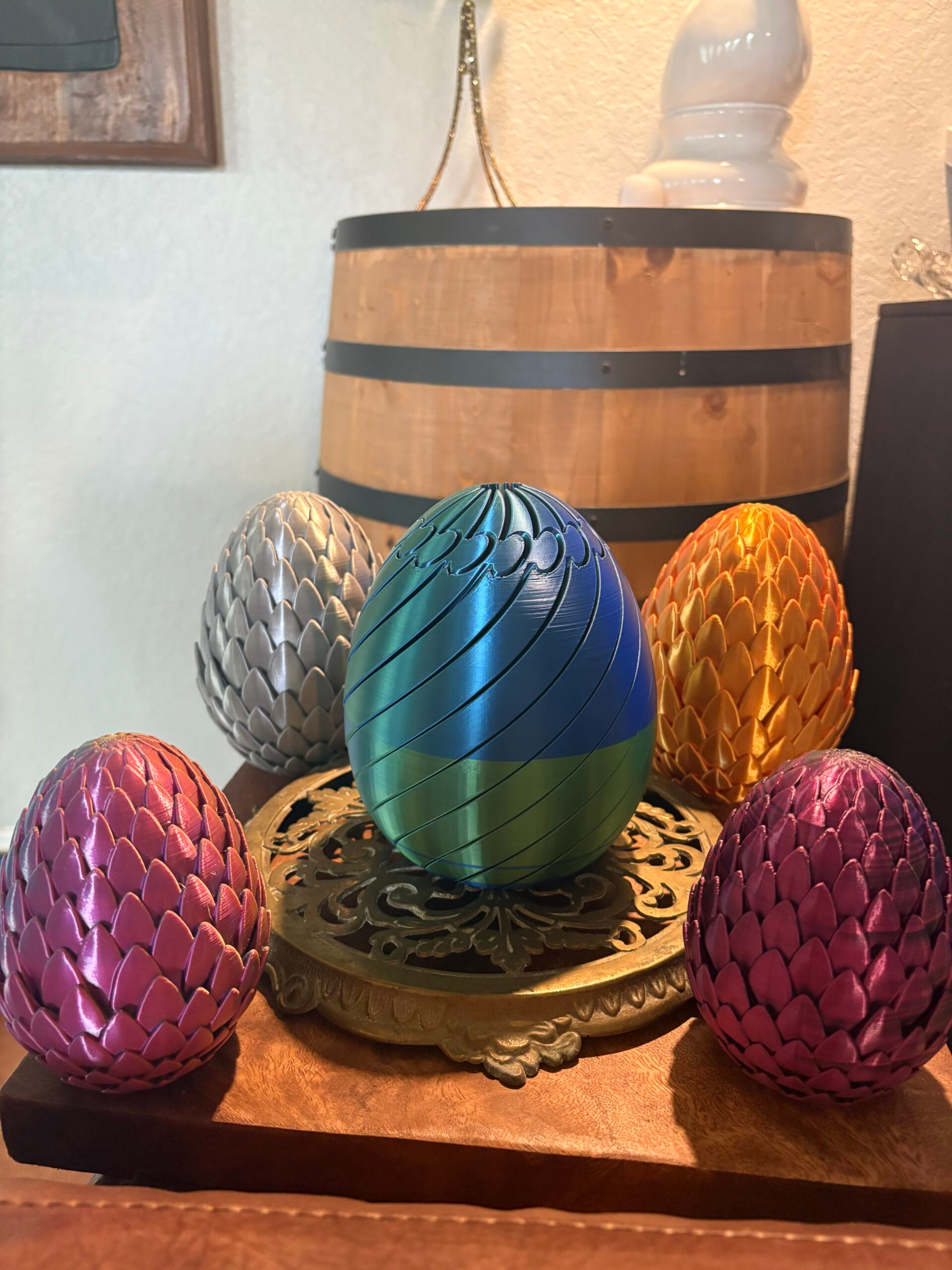 Colorful 3D printed dragon eggs that open to reveal articulated dragon figures inside.