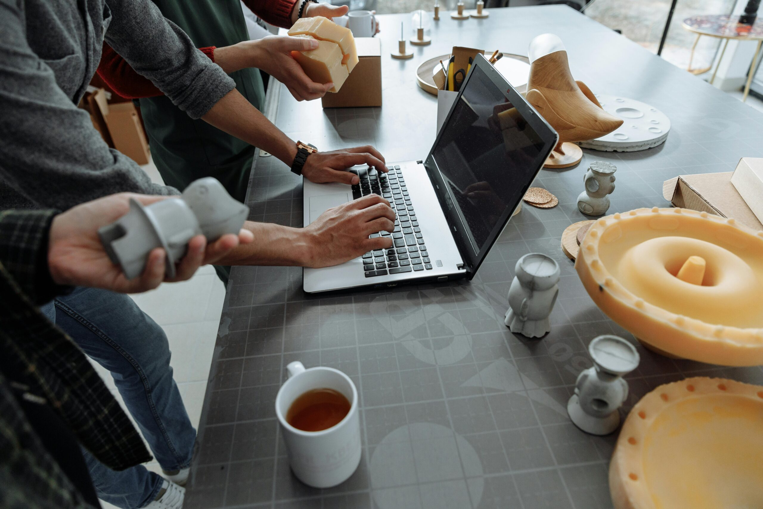 Designers reviewing custom 3D printed prototypes and CAD models during a product development and custom manufacturing project.