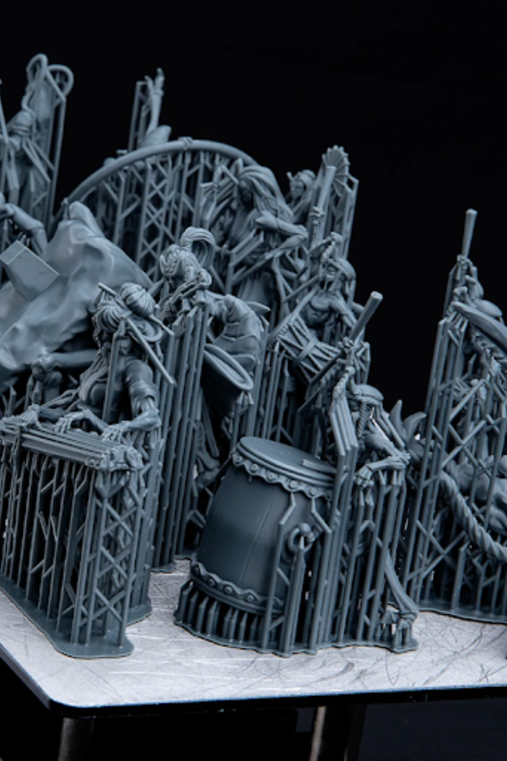 High-detail resin 3D printed models displayed with support structures before post-processing and finishing.
